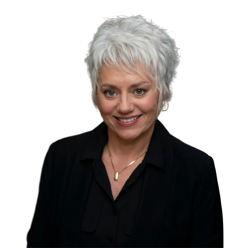 Headshot of Jackie Vick smiling, isolated on transparent background, wearing black blazer